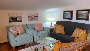 Sala de estar con 2 sofás y mesa en LOFT SUSANA, en San Vicente de la Barquera