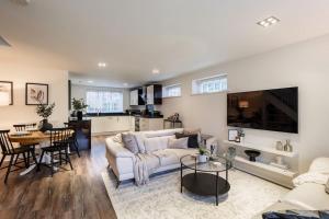 a living room with a white couch and a table at Tranquil Riverfront Oasis at High Bridge Court in Knaresborough