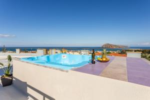 a swimming pool on the roof of a house at kallia's lux apt with sea view & cool jacuzzi in Plataniás