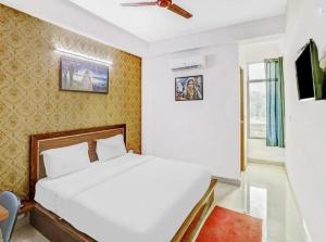 - une chambre avec un lit blanc et une fenêtre dans l'établissement Kastle Guest House, à New Delhi