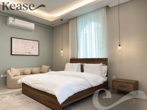 a bedroom with a large bed and a couch at Kease Al-Mutamarat A-13 Timeless History GX22 in Riyadh