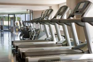 a row of treadmill machines in a gym at The Westin Dallas Park Central in Dallas