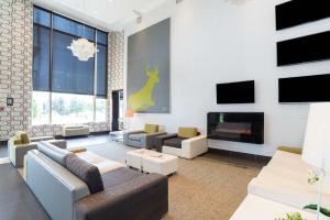 a living room with a couch and a fireplace at Sandman Hotel & Suites Calgary South in Calgary