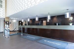 a lobby of a hotel with a reception desk at Sandman Hotel & Suites Calgary South in Calgary