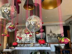three disco balls hanging from the ceiling in a restaurant at Pensjonat Cezar in Siemiatycze