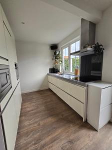 a kitchen with a sink and a counter top at Tip Top vakantie Woning Vlissingen in Vlissingen