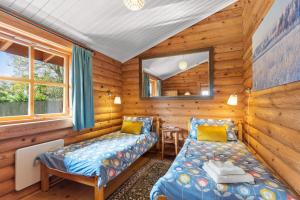 a log cabin with a bed and a mirror at Bluebells in Highampton