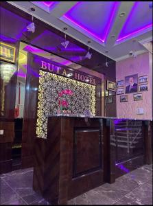 a bar in a hotel with purple lights at Buta Hotel Berde 