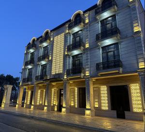 a building with lights on the side of a street at Buta Hotel Berde in Bǝrdǝ