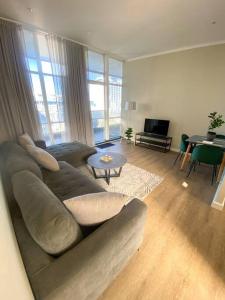 a living room with a couch and a table at Spacious 2-bed unit no-powercuts in Cape Town