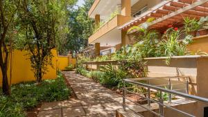 a walkway in front of a building with plants at Exquisite 2 Bedroom, Lux Living at Riverside in Nairobi