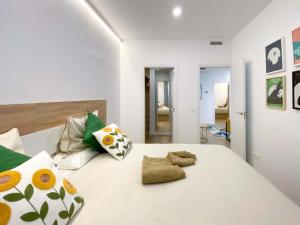 a bedroom with a white bed with pillows at Refugio 2BR y 2BA Azca/Bernabéu in Madrid