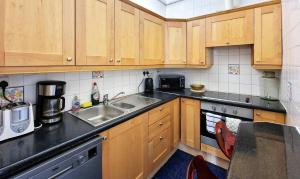 a kitchen with wooden cabinets and a sink at Walking distance to Grafton St in Dublin