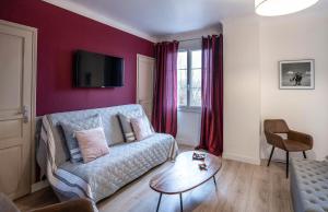 a living room with a couch and a table at La Bayardine in Sarlat-la-Canéda