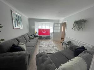 a living room with a couch and a flat screen tv at Large Lytham Home - The Birds View by Holiday Heim in Lytham St Annes
