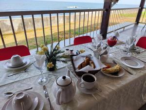 a table with a white table cloth with food on it at HOTEL DE L'OCEAN KRIBI in Kribi
