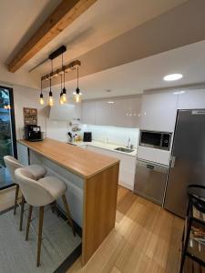 a kitchen with a wooden counter top in a room at Passivhaus con jardín en La Rioja in Entrena