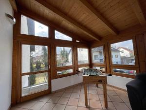 a room with windows and a table with a chessboard at Worker Apartments near Ulm bis zu 11 Betten in Dornstadt