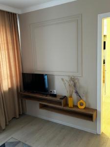 a living room with a flat screen tv on a shelf at люкс квартира в центре города - все удобства - ждем Вас! in Karagandy