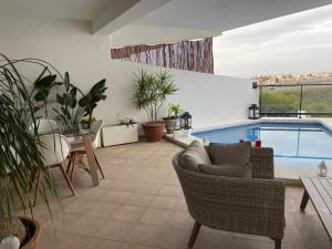 a living room with a pool and a table and chairs at Hollywood POOL luxury in Mijas