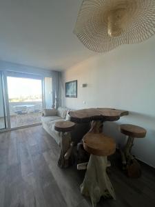 a living room with a table and two stools at Les Restanques du golfe de St Tropez in Grimaud