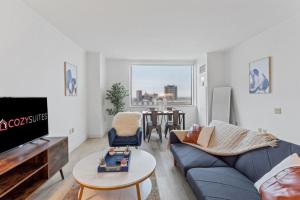 a living room with a blue couch and a table at CozySuites at Showboat 1BR 2BA OceanFront Villa in Atlantic City