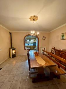 a dining room with a table and a stove at A casa della nonna in Seano