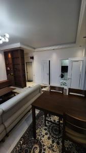 een woonkamer met een bank en een tafel bij APARTMENT SILVER HOUSE in Samarkand