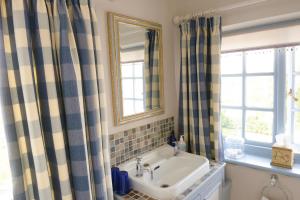 a bathroom with a sink and a mirror at Colly Farm in Bridport