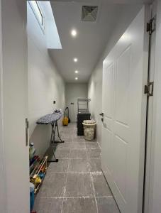 a hallway with a white door and a table at Madinah Valley Residency Room 1 in Sulţānah