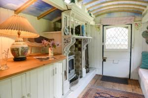 a room with a table with a lamp on a counter at Colly Farm in Bridport +30 photos