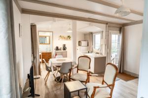 a kitchen and living room with a table and chairs at La Bayardine in Sarlat-la-Canéda