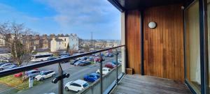 a balcony with a view of a parking lot at Large Bright Apartment by Dun Laoghaire Harbour in Dublin