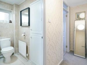 a bathroom with a toilet and a mirror at Pass the Keys Lovely Home in Holywood Lots Nearby Seaside in Holywood +31 photos