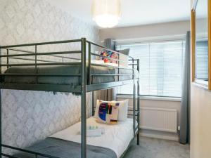 a bedroom with two bunk beds and a window at Pass the Keys Lovely Home in Holywood Lots Nearby Seaside in Holywood