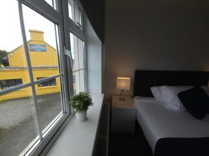 1 dormitorio con cama y ventana grande en Holiday in The Heart of Kerry, en Castlemaine