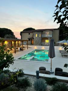 une maison avec une piscine dans une cour dans l'établissement Olivea Luxury Suites, à Fažana