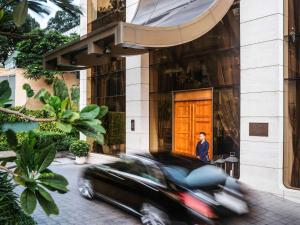 a black car in front of a building at Hotel Des Arts Saigon Mgallery Collection in Ho Chi Minh City