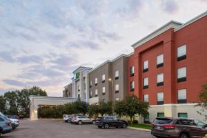 a large building with cars parked in a parking lot at Holiday Inn Express & Suites Sioux City-South by IHG in Sioux City