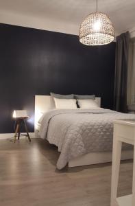 a bedroom with a white bed and a black wall at Residential Hotels Grand Central in Helsinki