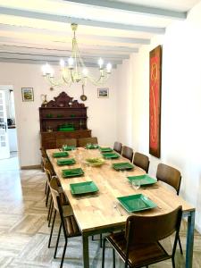 a dining room with a large wooden table with chairs at Maison de Vacances La Commanderie in Mormoiron