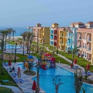 a view of a pool with a water park at Porto Matroh New Chalets in Marsa Matruh