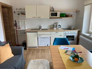 a living room with a table and a kitchen at Haus Werner in Ramsau am Dachstein