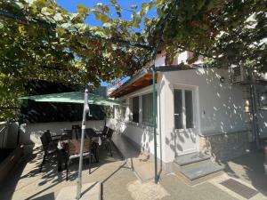 een patio met een tafel en stoelen en een parasol bij Apartments in Medulin - Istrien 46722 in Medulin