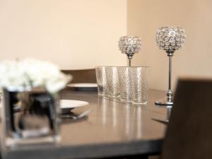 a table with three glasses on top of it at Luxury 2 Bed Apartment – Near Heathrow, Legoland, Windsor Slough in Slough