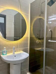 a bathroom with a sink and a mirror at Urban Haven in Lekki