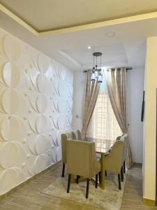 a dining room with a dining table and chairs at Urban Haven in Lekki