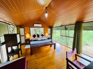 a bedroom with a bed and a table in a room at Green Wild Yala - Luxury Camping & Free Safari Tour in Yala