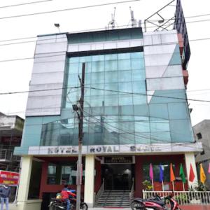 a tall glass building with flags in front of it at GRG Royal Surya Inn Gaya in Gaya