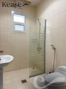 a bathroom with a shower and a toilet and a sink at Kease Al-Mutamarat A-10 Timeless History GX66 in Riyadh
